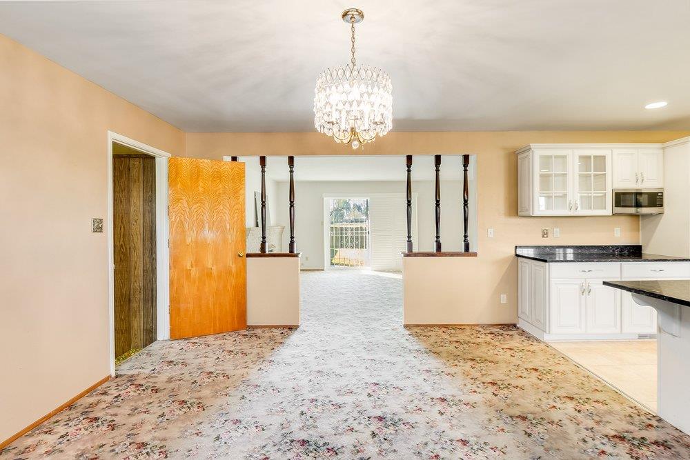10486 Spaulding Way Rancho Cordova, CA 95670 - Photo 21 of 74 a large kitchen with kitchen island granite countertop a refrigerator a stove a sink dishwasher with wooden floor and dining table