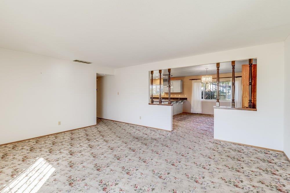 10486 Spaulding Way Rancho Cordova, CA 95670 - Photo 25 of 74 a view of empty room with wooden floor and kitchen view