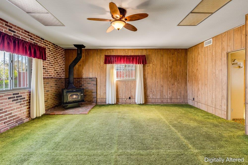 10486 Spaulding Way Rancho Cordova, CA 95670 - Photo 28 of 74 a view of a livingroom with a fireplace a ceiling fan and windows