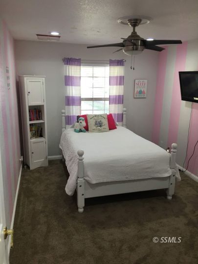 217 Rancho Street Ridgecrest, CA 93555 - Photo 11 of 25 a bedroom with a bed and a window