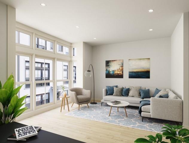 a living room with furniture and a potted plant