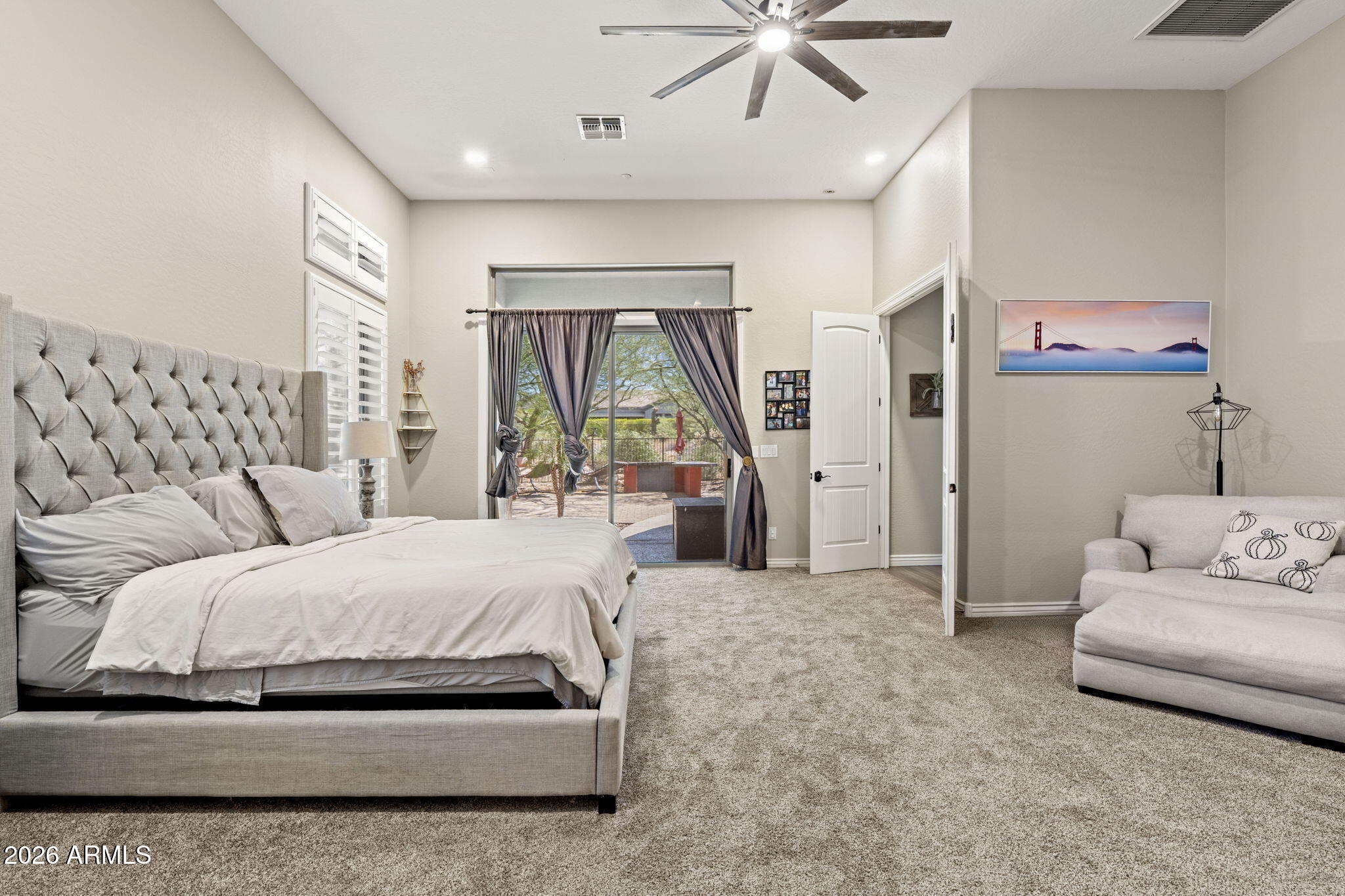 41619 North River Bend Road Anthem, AZ 85086 - Photo 4 of 84 a spacious bedroom with a bed a couch and a large window