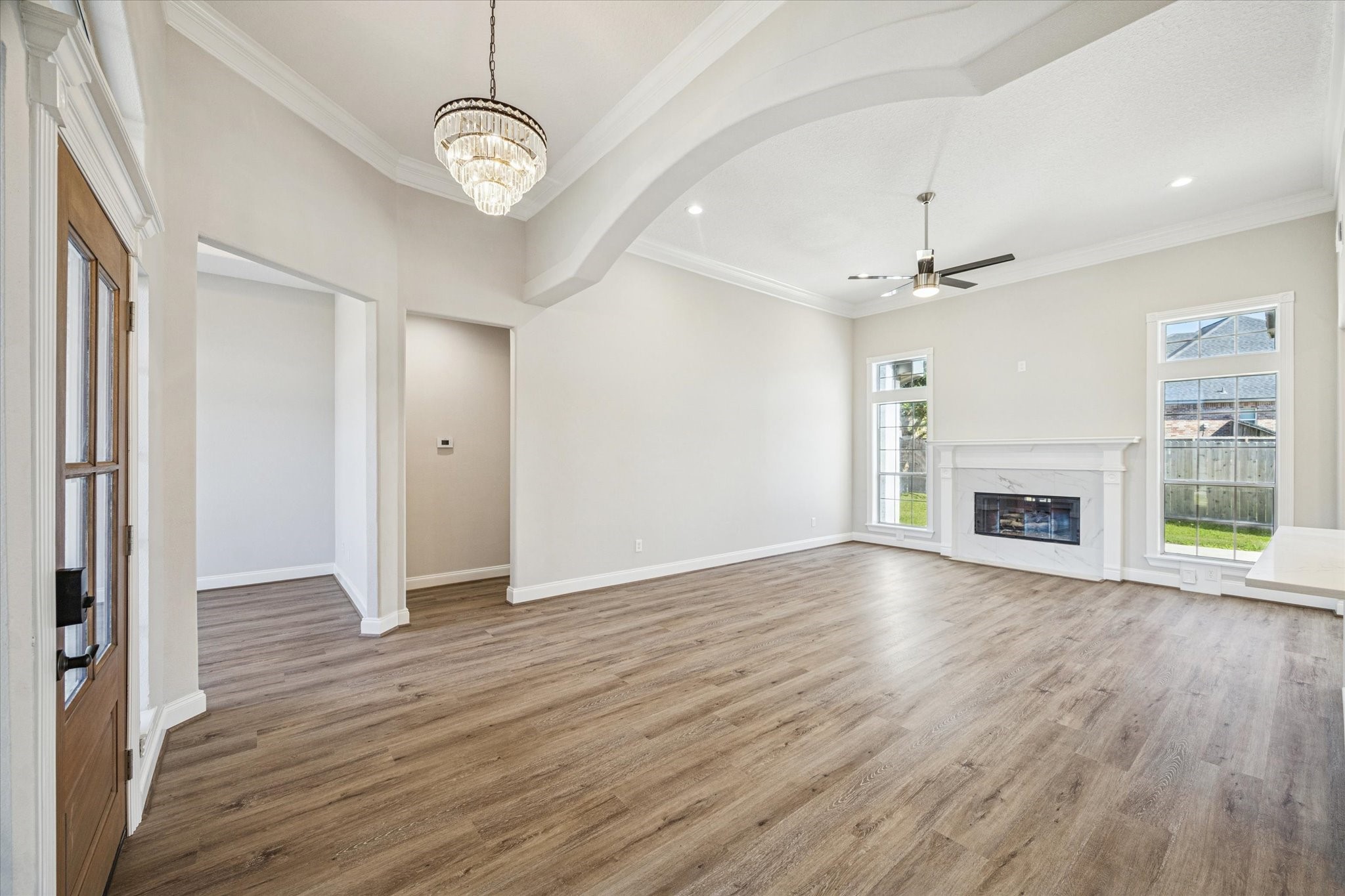 5437 Edgewater Court Willis, TX 77318 - Photo 6 of 29 a view of an empty room with wooden floor window and a kitchen