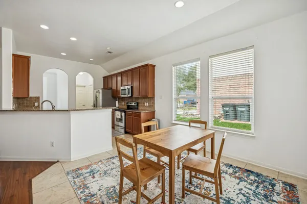 a view of a dining room with furniture and a window