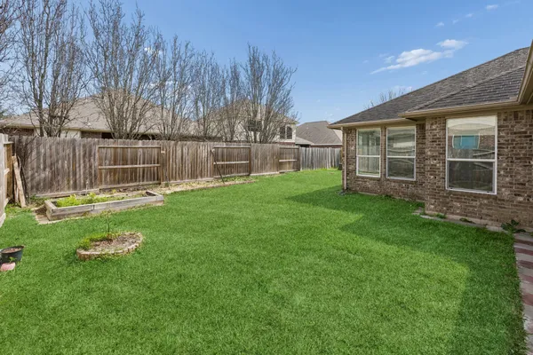 a backyard with a small garden and entertaining space