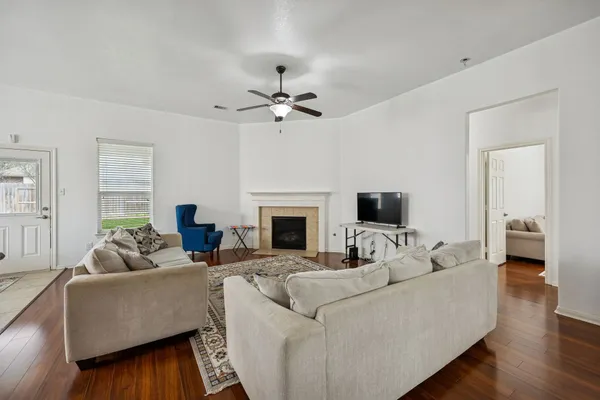 a living room with furniture a fireplace and a flat screen tv