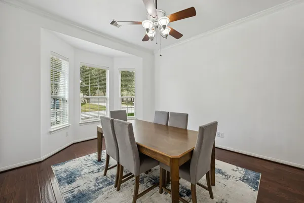 a view of a dining room with furniture window and wooden floor