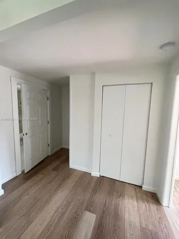 a view of an empty room and wooden floor