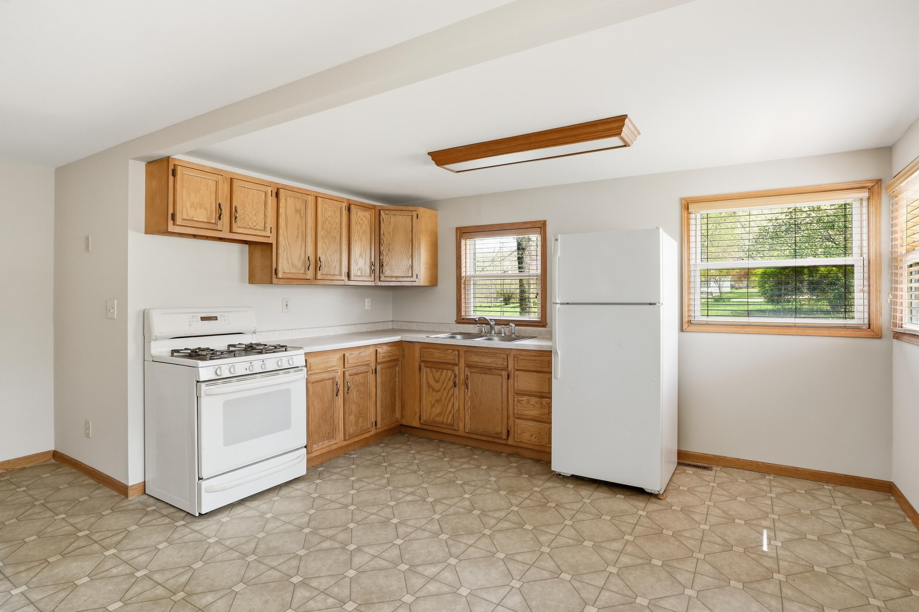 11131 Fathke Road Crown Point, IN 46307 - Photo 6 of 17 a kitchen with a stove and a refrigerator