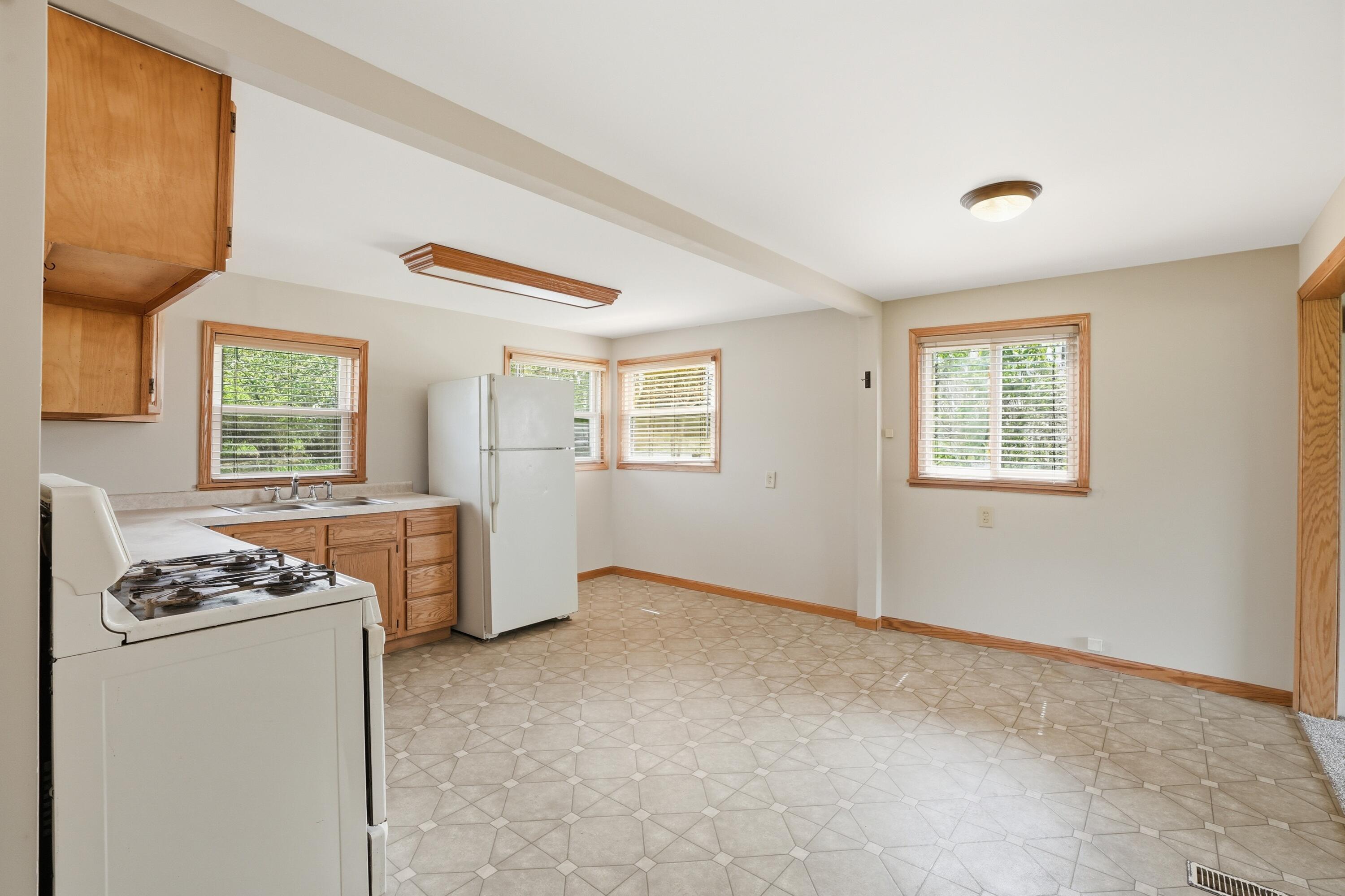 11131 Fathke Road Crown Point, IN 46307 - Photo 9 of 17 a view of kitchen with windows cabinets and refrigerator