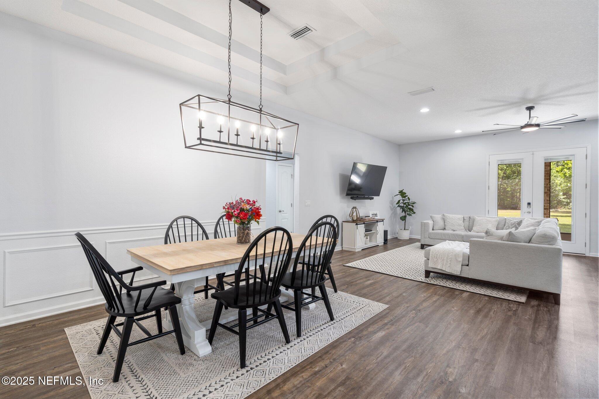 1309 Foxmeadow Trail Middleburg, FL 32068 - Photo 12 of 48 a view of a dining room with furniture wooden floor and chandelier