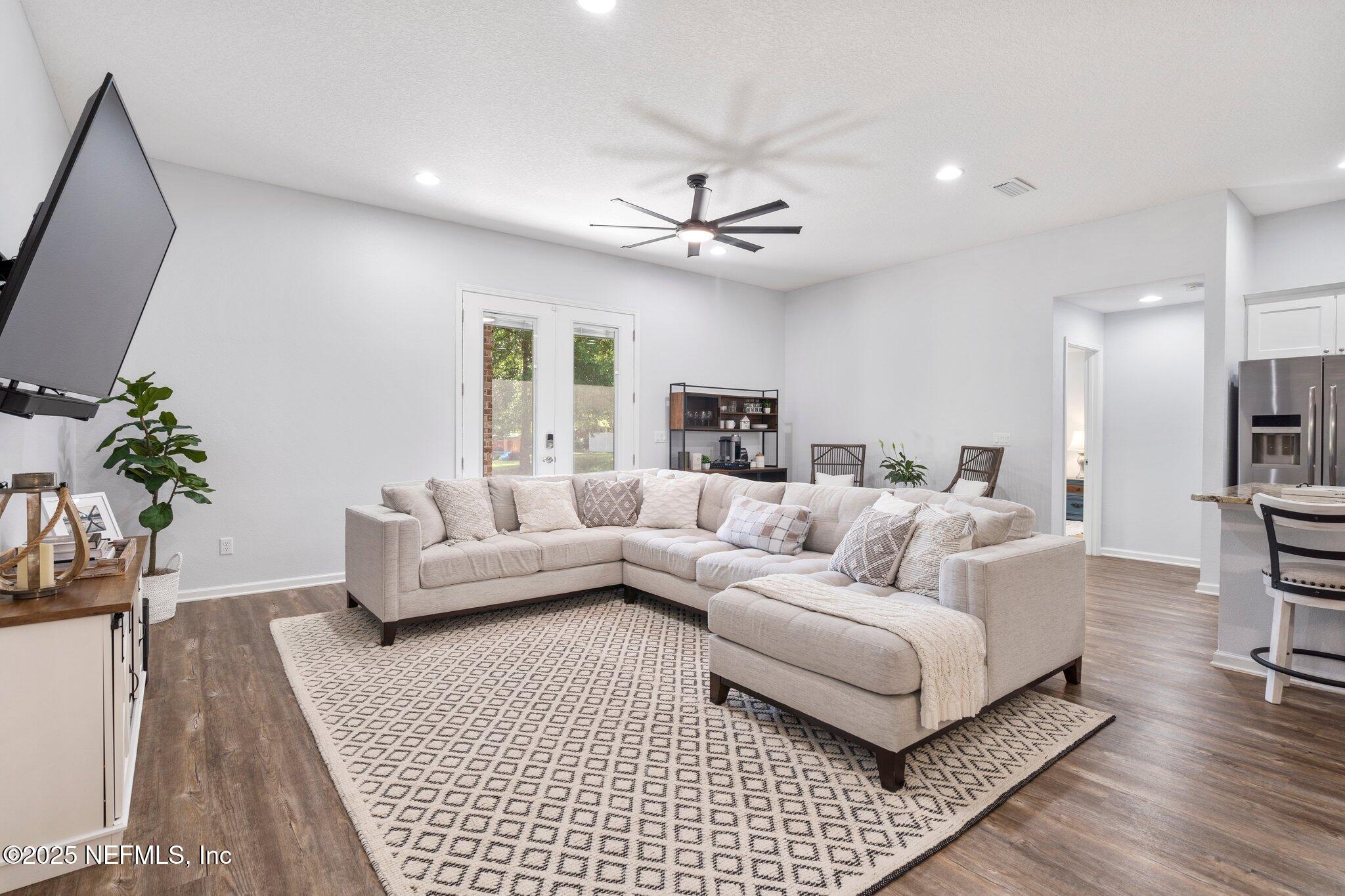 1309 Foxmeadow Trail Middleburg, FL 32068 - Photo 13 of 48 a living room with furniture and a flat screen tv