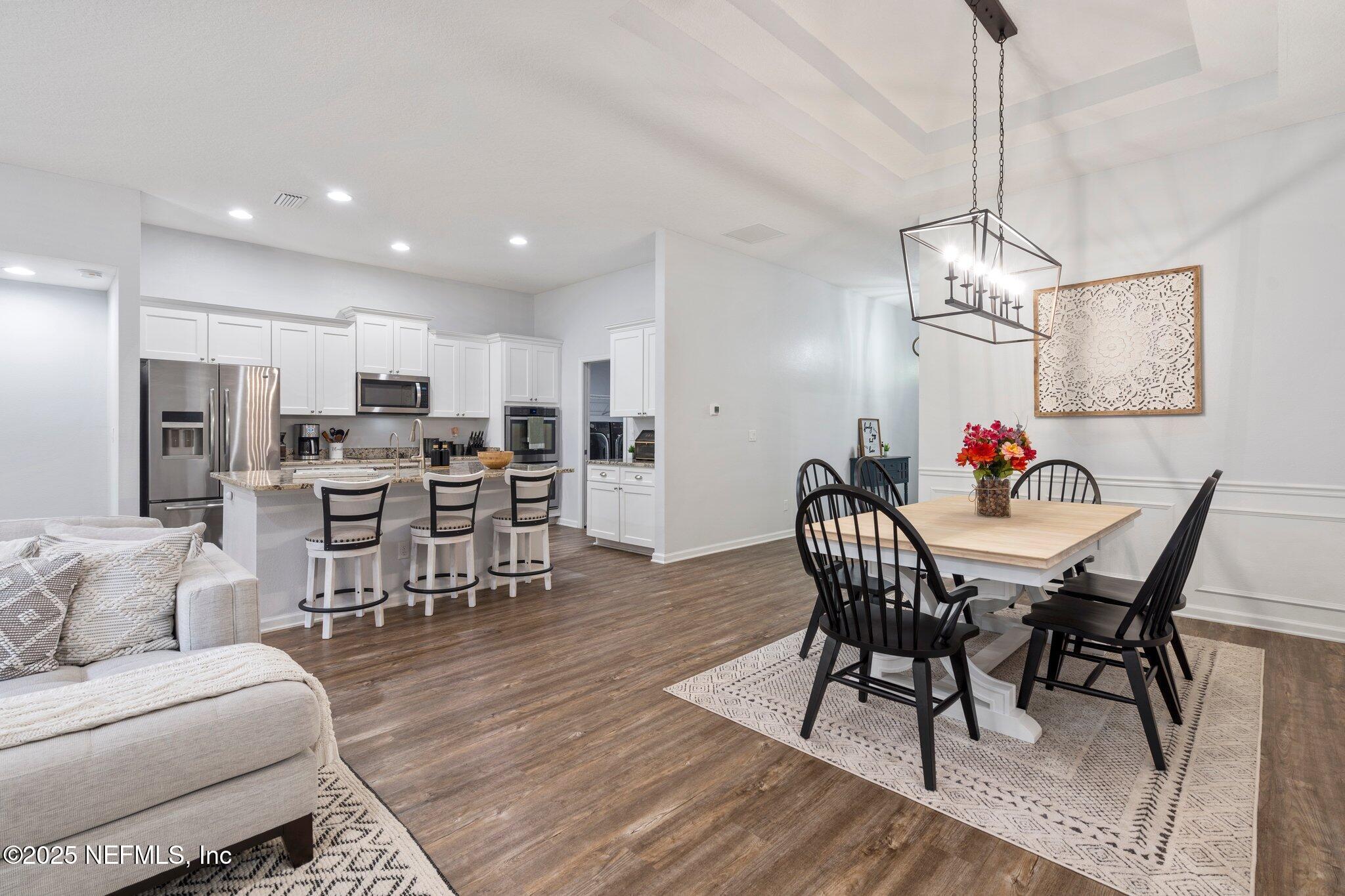 1309 Foxmeadow Trail Middleburg, FL 32068 - Photo 14 of 48 a view of a dining room with furniture wooden floor and chandelier