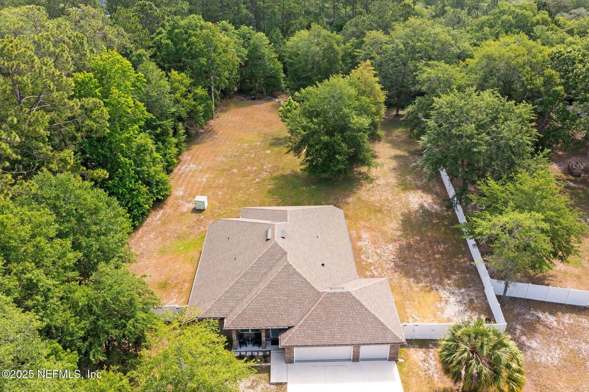 1309 Foxmeadow Trail Middleburg, FL 32068 - Photo 2 of 48 an aerial view of a house with a yard and trees all around