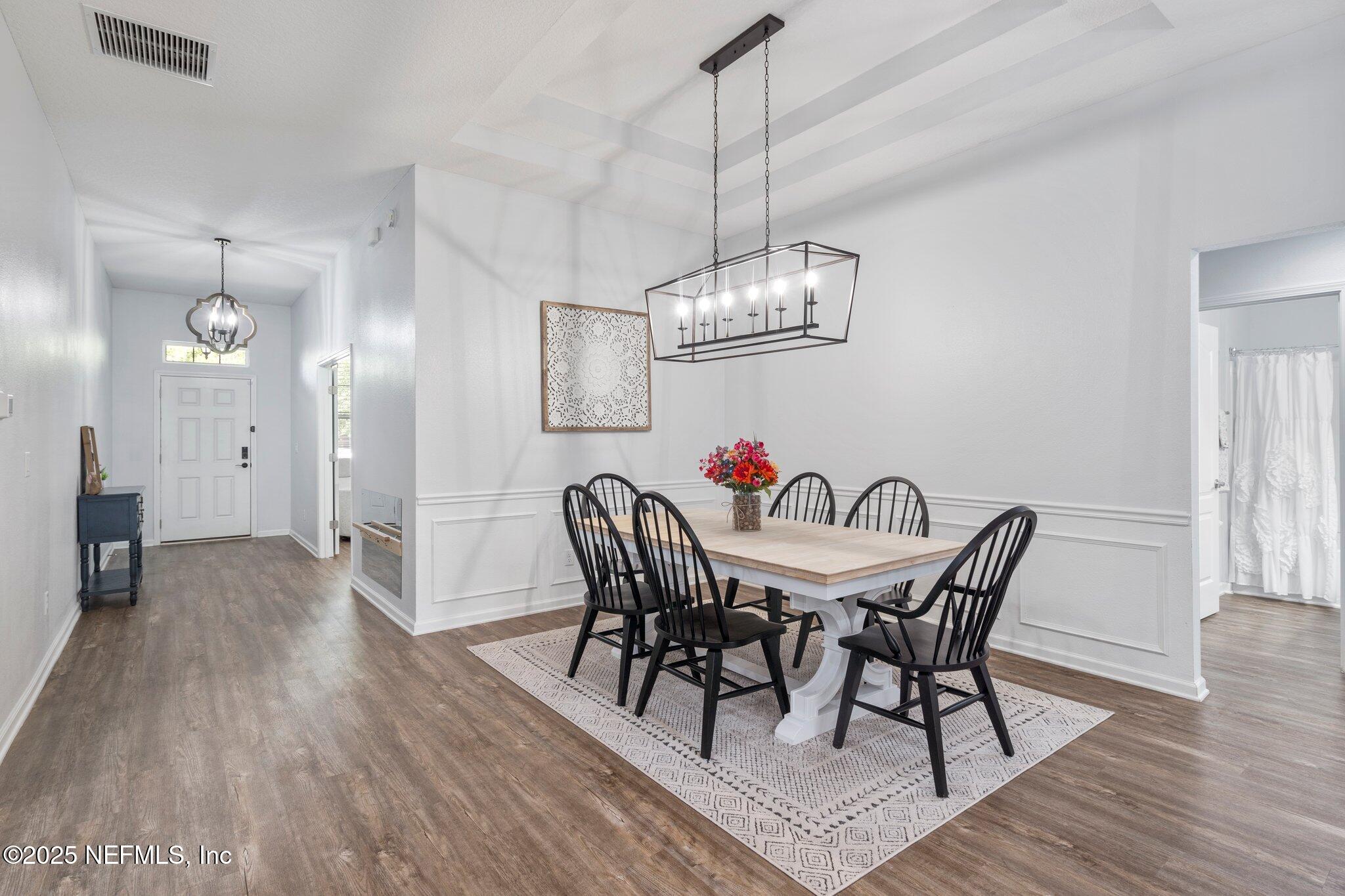 1309 Foxmeadow Trail Middleburg, FL 32068 - Photo 21 of 48 a view of a dining room with furniture wooden floor and chandelier