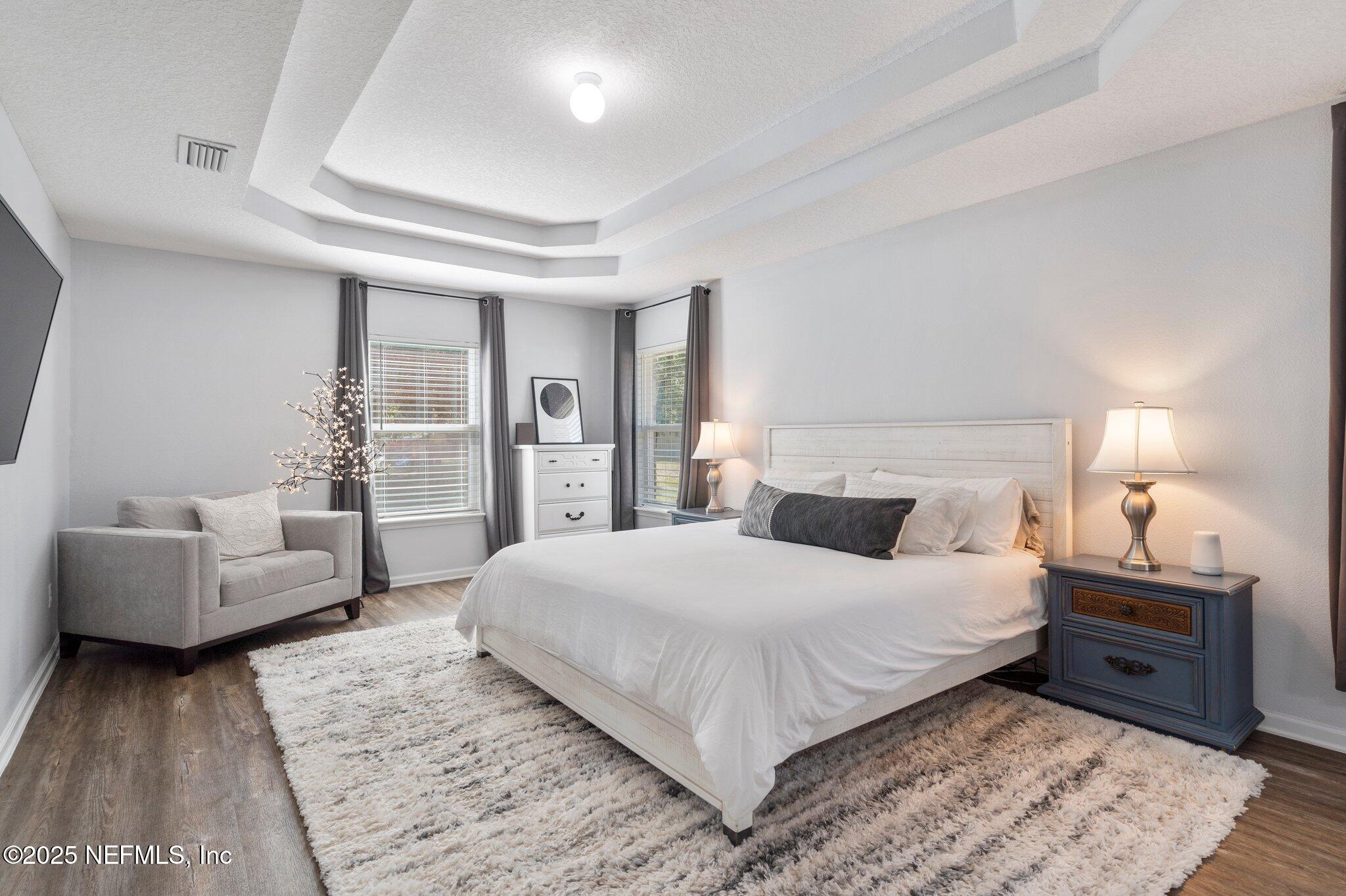 1309 Foxmeadow Trail Middleburg, FL 32068 - Photo 22 of 48 a bedroom with a large bed and a couch