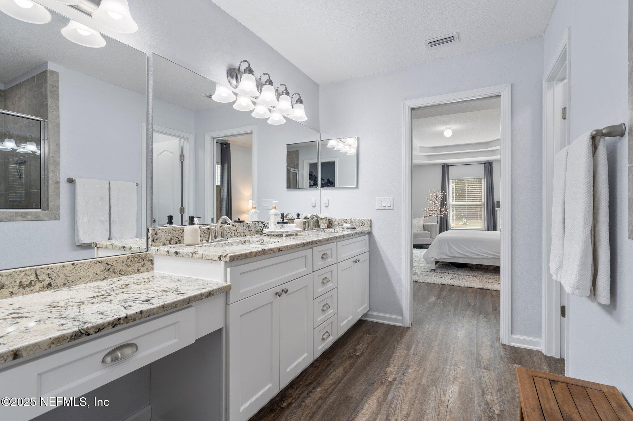 1309 Foxmeadow Trail Middleburg, FL 32068 - Photo 25 of 48 a spacious bathroom with a granite countertop sink and a mirror