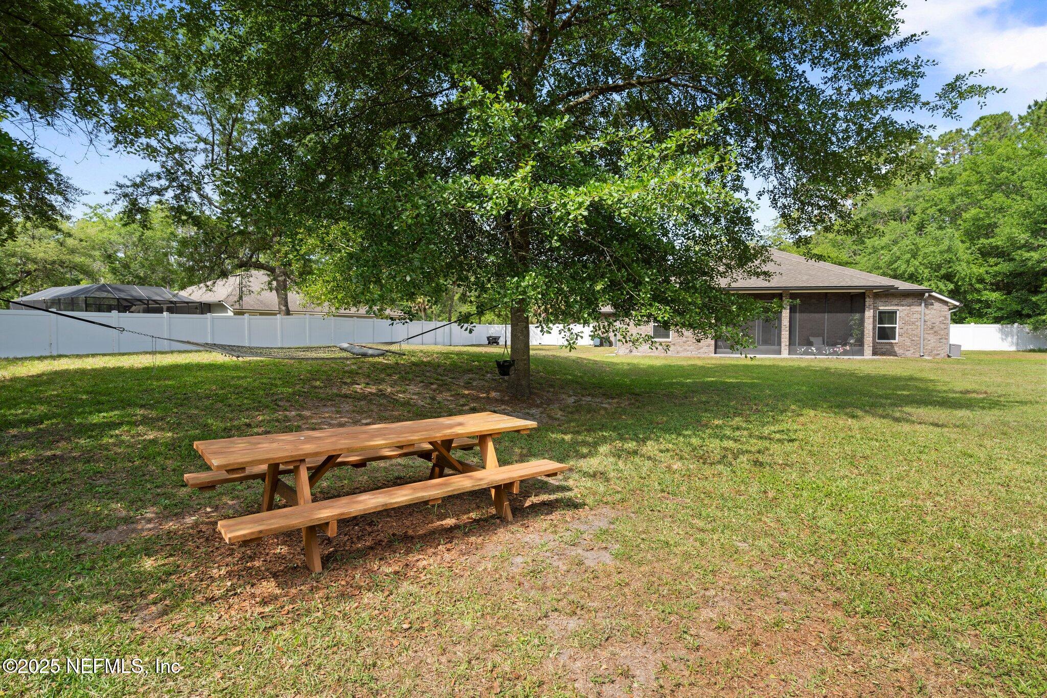 1309 Foxmeadow Trail Middleburg, FL 32068 - Photo 35 of 48 a view of a house with a yard porch and sitting area