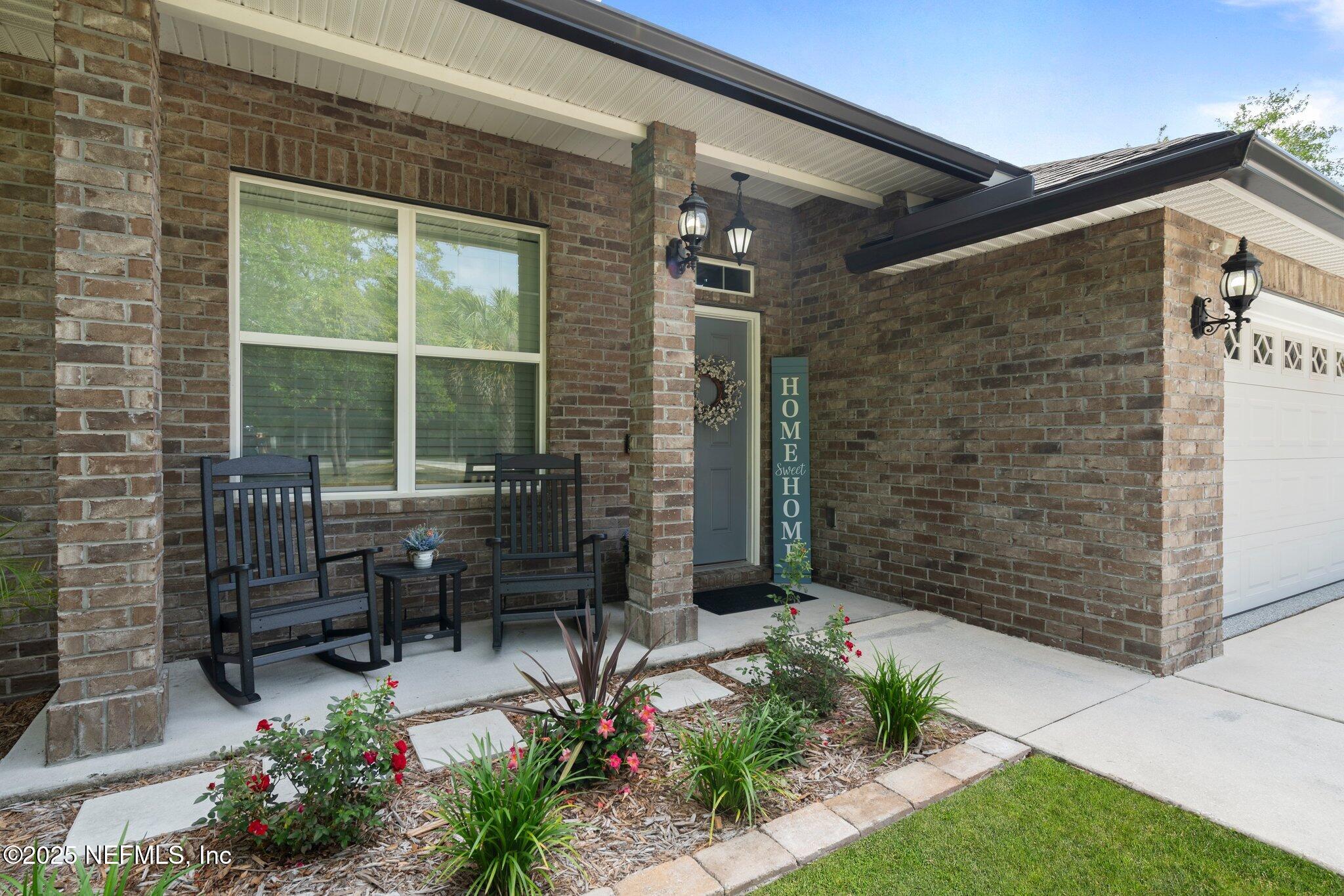 1309 Foxmeadow Trail Middleburg, FL 32068 - Photo 39 of 48 a view of a patio with table and chairs and potted plants