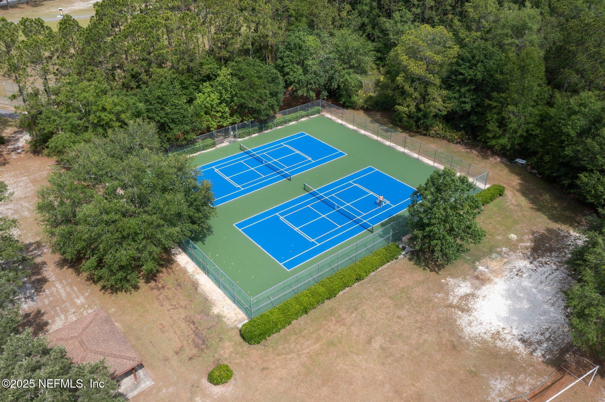 1309 Foxmeadow Trail Middleburg, FL 32068 - Photo 45 of 48 a view of a tennis ground with large trees