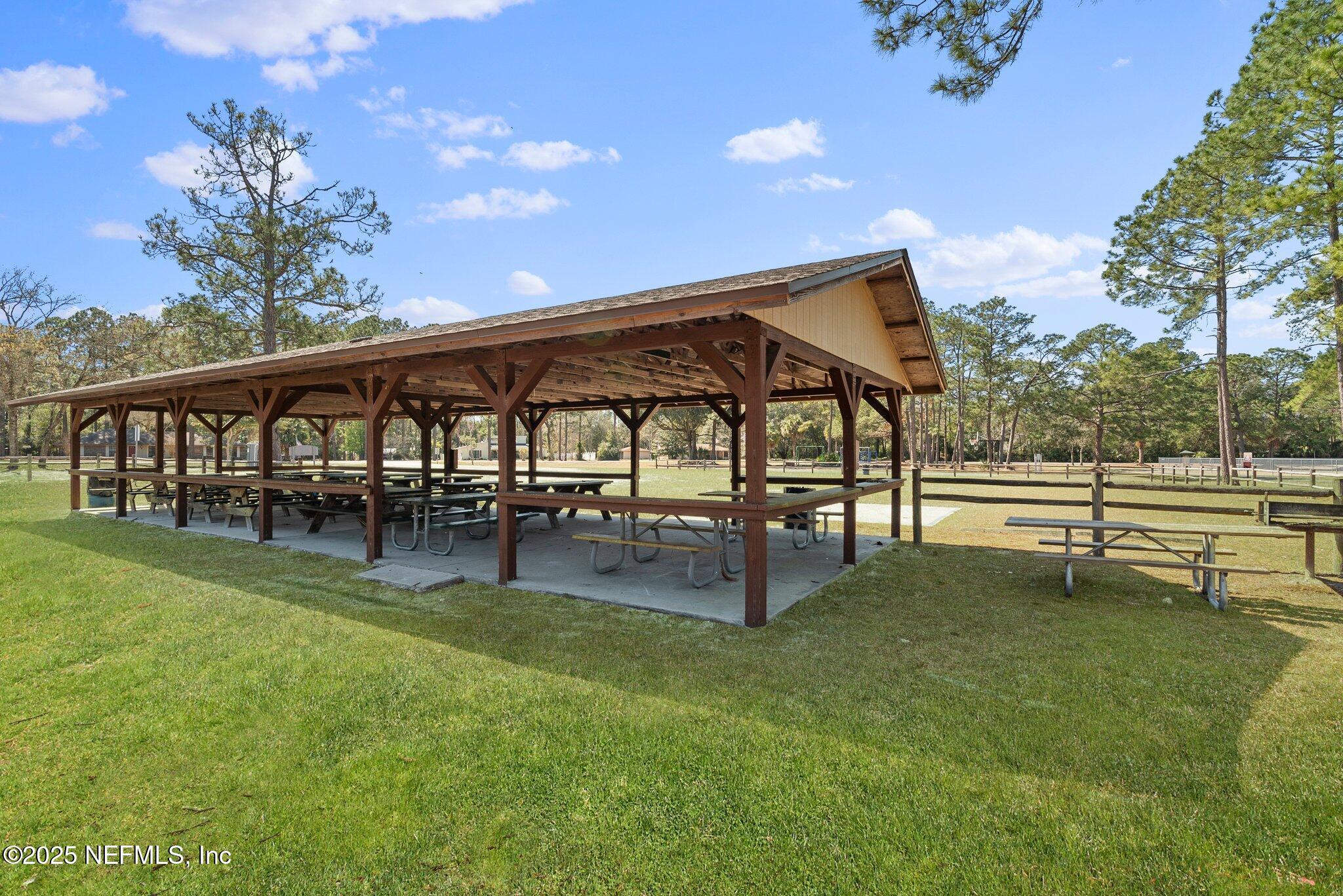 1309 Foxmeadow Trail Middleburg, FL 32068 - Photo 48 of 48 a view of a swimming pool with a bench and trees