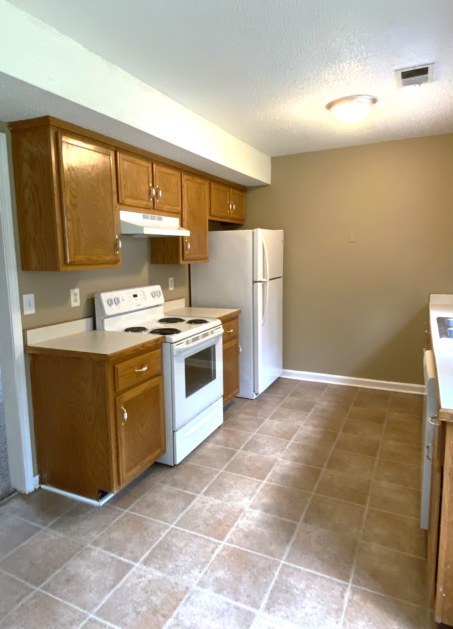 1009 Shadow Ridge Avenue Oak Grove, KY 42262 - Photo 3 of 14 a kitchen with a stove a sink and a refrigerator