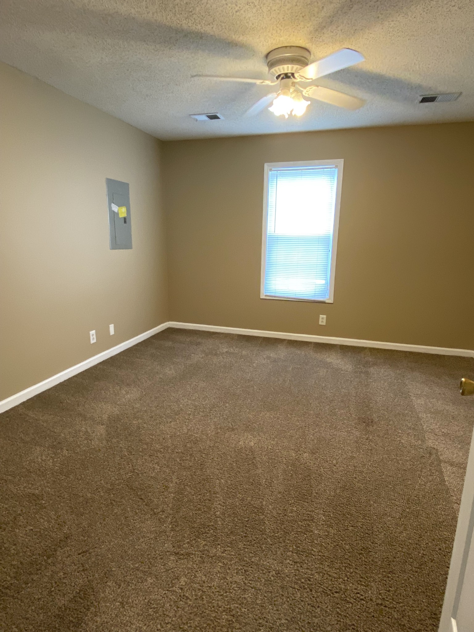 1009 Shadow Ridge Avenue Oak Grove, KY 42262 - Photo 6 of 14 an empty room with a window and a ceiling fan