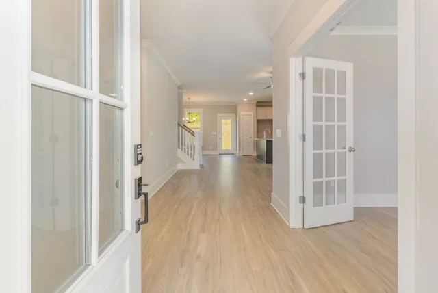 a view of a hallway with wooden floor and closet