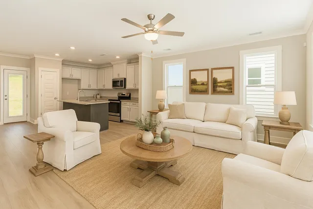 a living room with furniture a dining table and kitchen view