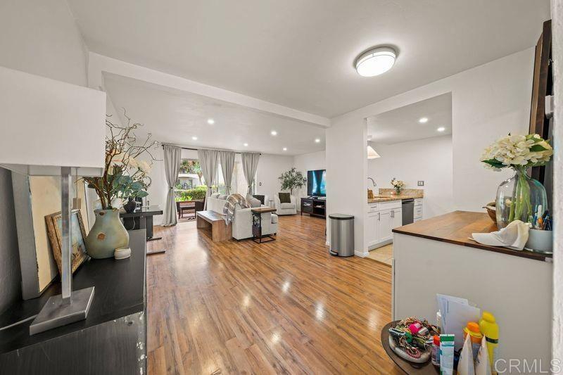 6009 Rancho Mission Road, Unit 102 San Diego, CA 92108 - Photo 1 of 1 a living room with furniture and a flat screen tv