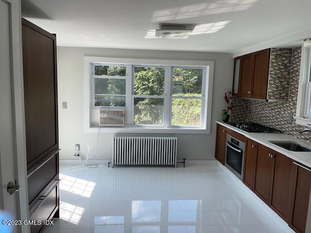 218 Pemberwick Road, Unit 2 Greenwich, CT 06831 - Photo 3 of 20 a kitchen with a stove a sink and a refrigerator
