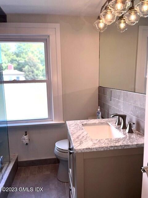 218 Pemberwick Road, Unit 2 Greenwich, CT 06831 - Photo 6 of 20 a bathroom with a sink a toilet and a window