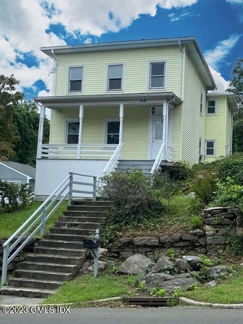 218 Pemberwick Road, Unit 2 Greenwich, CT 06831 - Photo 8 of 20 a front view of a house with garden