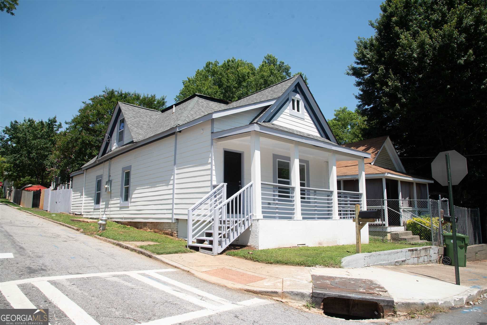 a front view of a house with garden and patio