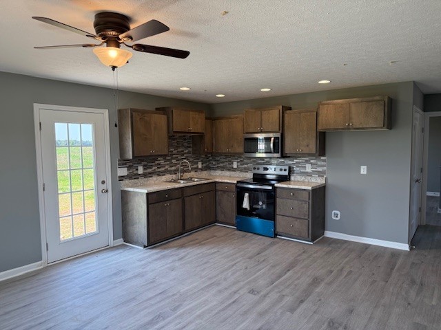 12 Hesselly Road Decherd, TN 37324 - Photo 2 of 12 a kitchen with stainless steel appliances kitchen island granite countertop a stove a sink a refrigerator and a microwave
