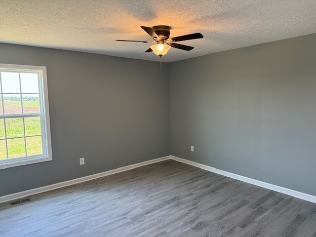 12 Hesselly Road Decherd, TN 37324 - Photo 7 of 12 an empty room with wooden floor and windows