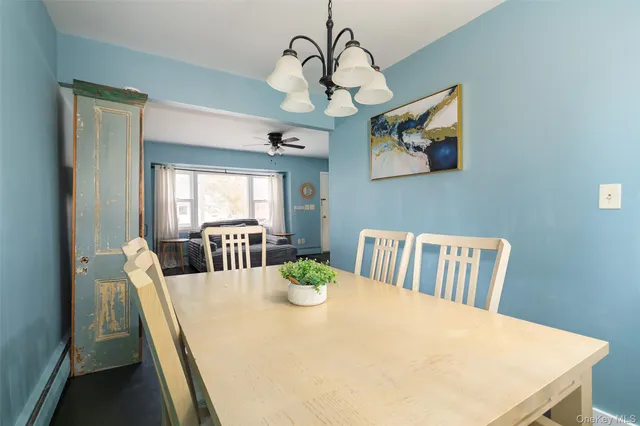 a view of a dining room with furniture wooden floor and chandelier