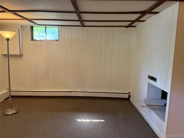a room with pool table and windows