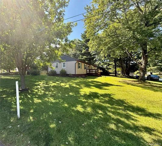 a view of backyard with deck and garden