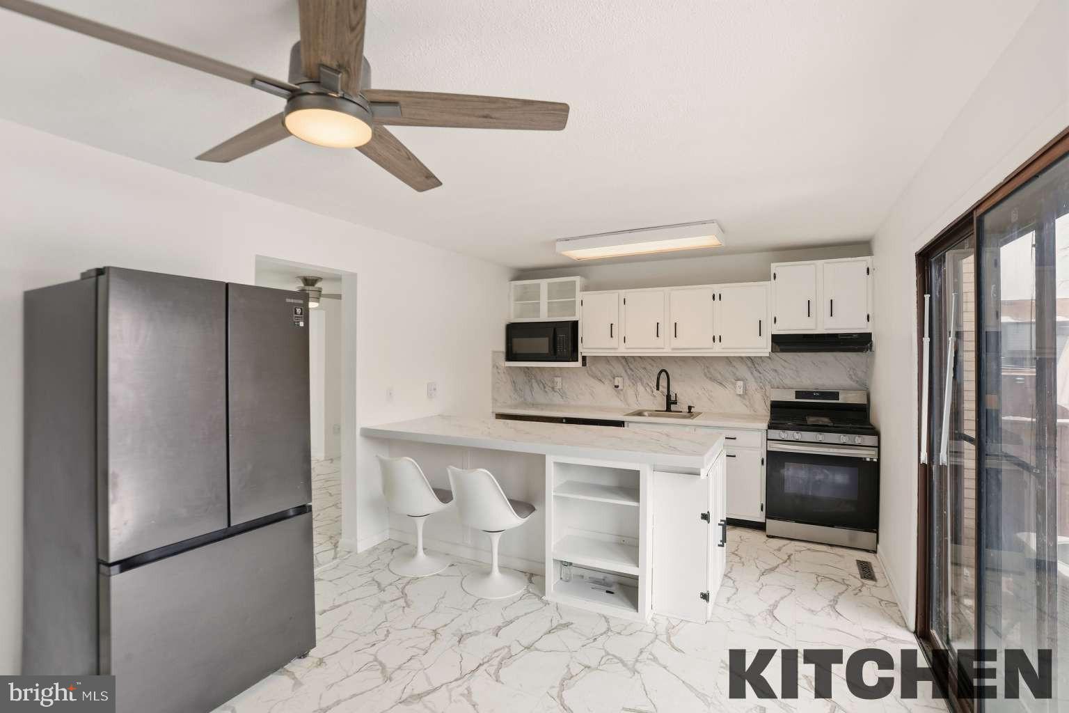 960 Jamestown Road Hightstown, NJ 08520 - Photo 6 of 18 a kitchen with stainless steel appliances granite countertop a refrigerator stove and microwave
