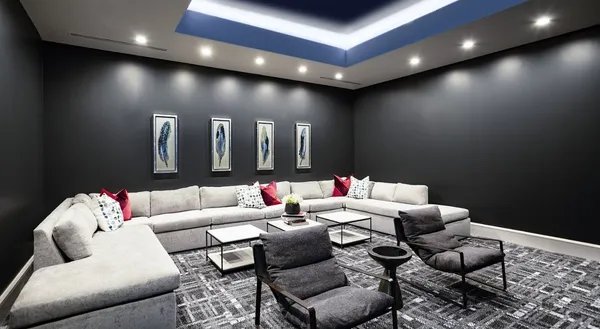 a living room with furniture kitchen view and a chandelier