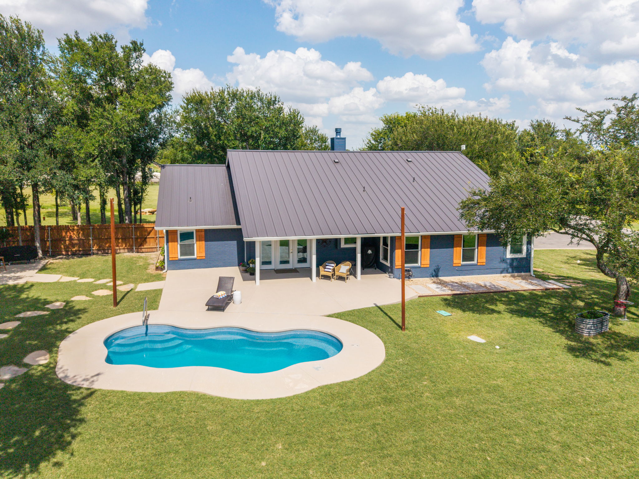 3001 County Road 255 Georgetown, TX 78633 - Photo 3 of 35 An inviting backyard oasis awaits with a sparkling free-form pool and ample patio space for leisure.