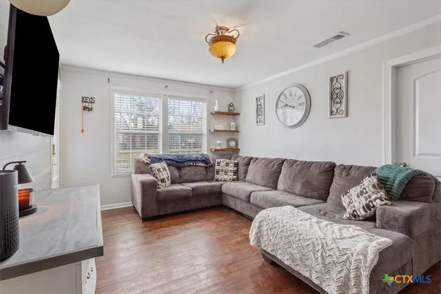 a living room with couches and a flat screen tv