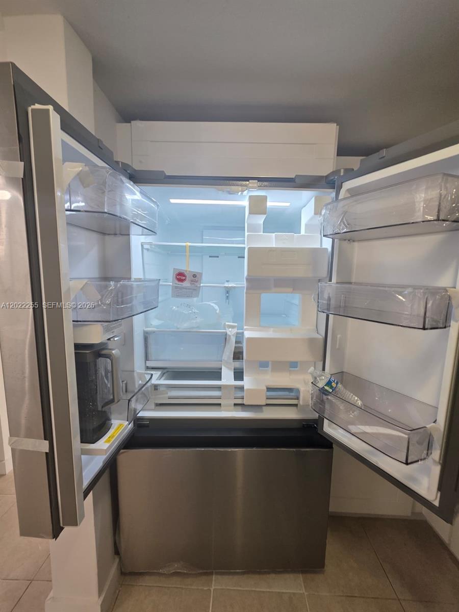 829 Southwest 3rd Street, Unit 831 Miami, FL 33130 - Photo 16 of 21 a room with water heater and racks