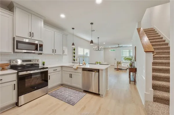 a kitchen with sink cabinets and stainless steel appliances