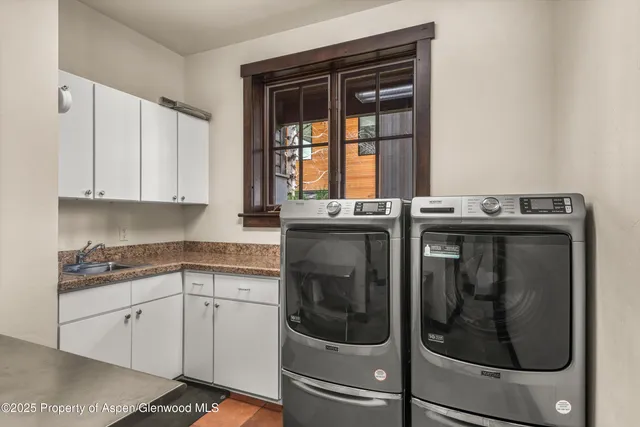 a bathroom with a granite countertop sink a large mirror and a toilet