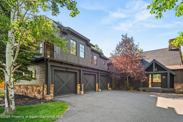 a view of a living room with wooden floor and a fireplace