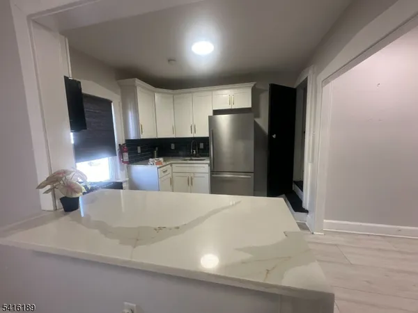 a kitchen with stainless steel appliances a refrigerator sink and microwave