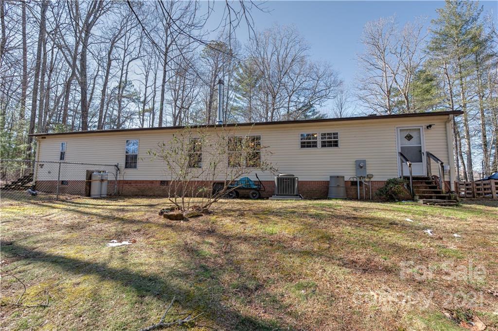 184 Terrys Gap Loop Road Fletcher, NC 28732 - Photo 28 of 28 a backyard of a house with table and chairs