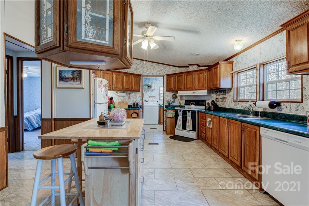 184 Terrys Gap Loop Road Fletcher, NC 28732 - Photo 6 of 28 a kitchen with stainless steel appliances kitchen island granite countertop a sink and cabinets
